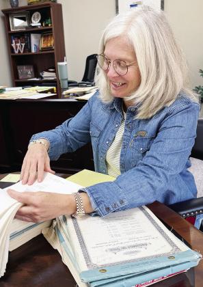 Jill Weedon goes over documents in her office. CDN | Shiann Dawson
