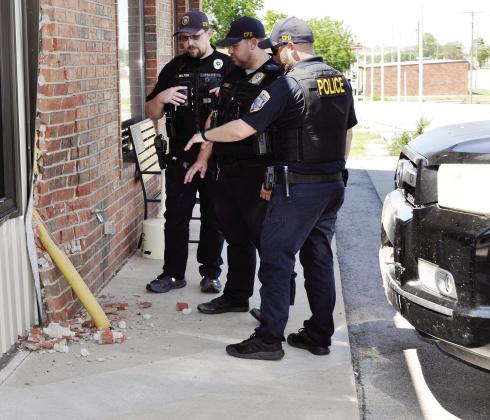 A little after 3 p.m. Tuesday, a Toyota SUV ran into the Diamond Wash located at 306 N. Fourth St. Surveying the damage at the laundromat are, from left, SRO Andrew Wilson, Officer Tucker Stevens, and SRO Dillon Whitten of the Clinton Police Department. CDN | Staff Photo