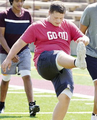 Clinton’s Isaiah Dustman performs high kicks prior to football practice in the Tornado Bowl. CDN | Sam Goodwyn