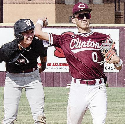 Clinton’s Declan Brown, right, throws the ball back to the pitcher after trying to keep the Weatherford runner at second during the Reds’ summer game against the Eagles. CDN | Sam Goodwyn