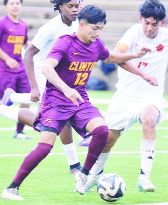 Clinton’s Austin Reynaga, left, hustles with the ball to outrace the Douglass player during the Reds’ home game Tuesday against the Trojans. CDN | Sam Goodwyn