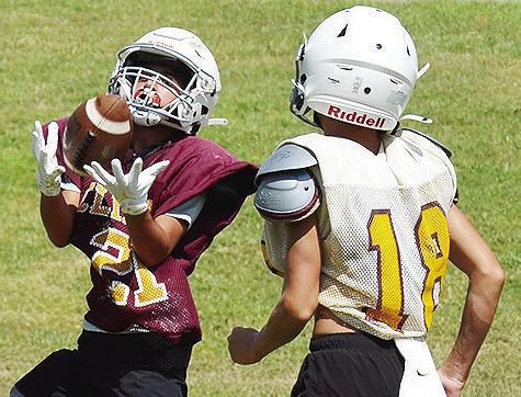 Clinton’s BentLee Potter, left, catches the ball right in front of Chance Roper during practice at the Middle School. CDN | Sam Goodwyn