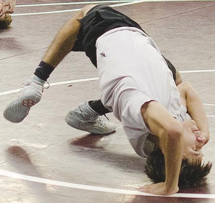Brandon Rodriguez-Escalante bridges off his back during wrestling practice. CDN | Sam Goodwyn