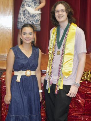 Idalia Pelayo Uribe, left, and Jackson McCullough were named the Red Tornado Boy and Girl of the Year Thursday night at the Senior Awards Ceremony. The packages behind them hold a minirefrigerator for their future dorm room. CDN | Christian Jacobsen