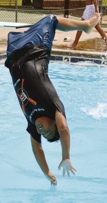 Cruz Standingwater gets too much bounce and his legs fly away at the Clinton Public Pool. CDN | Christian Jacobsen