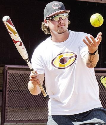 Clinton’s interim softball head coach Cooper Rhoads tosses the ball up to hit a pop fly Wednesday during practice at the high school. CDN | Sam Goodwyn