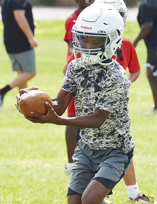 Tyree James catches the ball in the backfield before turning upfield during the first day of practice Monday. CDN |Sam Goodwyn