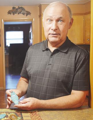 Kent Dewees shows off one of the two key fobs from Suite No. 215 of the, since demolished, Trade Winds Motel where Elvis Presley stayed. CDN | Micah Ashcraft