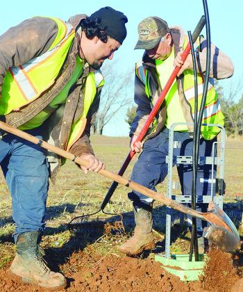 Michael Castillo, left, and Rancho Rodriguez replace and smooth out the dirt after excavating near a utility pole for maintenance Thursday morning on S. 28th Street. CDN | Micah Ashcraft