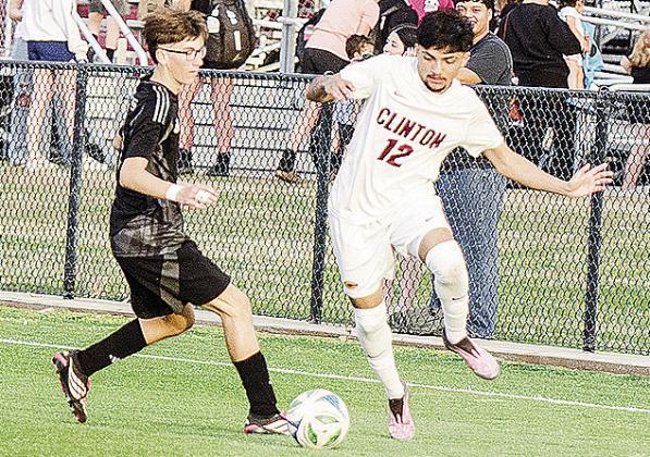 Clinton’s Austin Reynaga, right, battles a Weatherford player for control of the ball during the Reds’ road win Tuesday against the Eagles. CDN | Sam Goodwyn