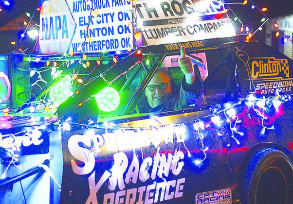 Rod Fauver gives a thumbs up while driving a Clinton Speed Bowl racecar in the Clinton Festival of Lights Christmas Parade. CDN | Micah Ashcraft