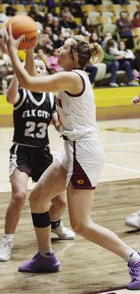 Lady Reds’ Odessa Musgrave fights against a Elk City opponent as she drives to the hoop in Clinton’s home game against the Elkettes. CDN | Sam Goodwyn