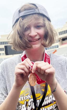 Raylei Harrel shows off her bronze medal during the State Special Olympics at OSU. CDN | Courtesy Photo