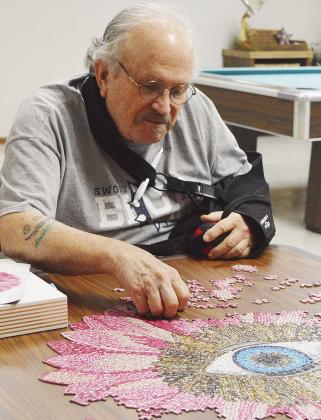 Larry Wilmeth keeps his eye on the prize while working on a puzzle as one of the activities available at the Oklahoma Veterans Center. CDN | Micah Ashcraft