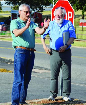 Steve Weichel, left, and Robert Johnston discuss the angle drivers would view the future Clinton Route 66 monument Friday on the corner of S. 10th Street and Opal Avenue. CDN | Christian Jacobsen