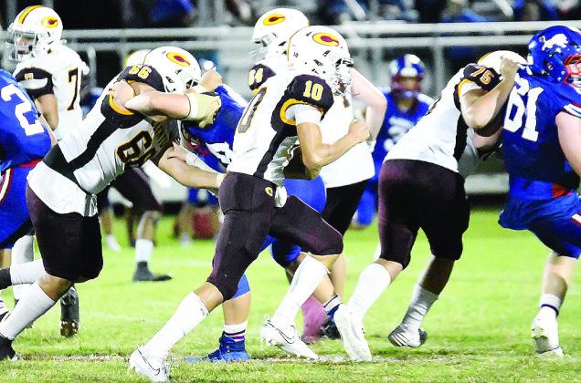 Clinton’s No. 10 JJ Ruiz carries the ball against Chandler Friday while No. 66 Andre Lime and No. 75 Eli Anderson provide blocks for him during the road game. CDN | John Kinsey
