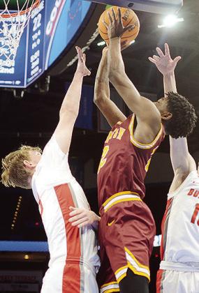 Clinton’s Atticus Thompson flies toward the basket for the layup over a Cache defender during the Reds’ “Court of Dreams” game in Oklahoma City against the Bulldogs. CDN | Sam Goodwyn