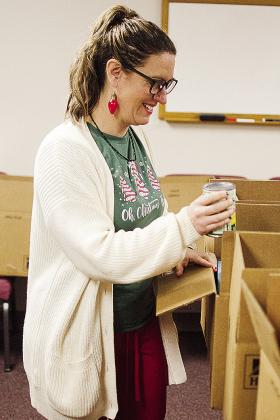 Jenny Maynard fills a blessings box Monday at Cornerstone Church. CDN | Sam Goodwyn