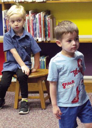 Lincoln Strauch, left, and Elliot Flores are focused on the story “Splish Splash Ducky” being read during storytime at Clinton Public Library. CDN | Christian Jacobsen