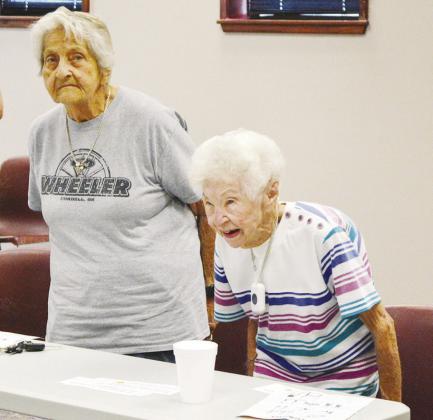 Carol Balzer, left, and Betty Madison do chair squats during their low-impact exercise class at Clinton Regional Hospital. CDN | Christian Jacobsen