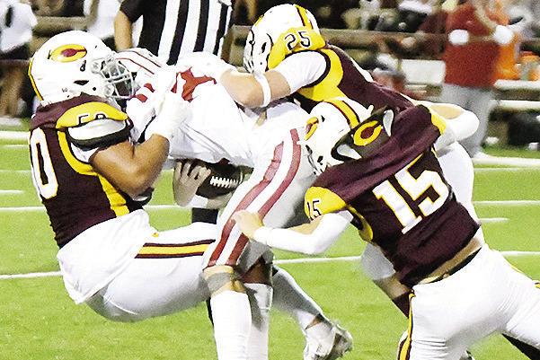 Clinton’s No. 50 Alex Amaya, No. 25 Gavin Evans and No. 15 Dyson Moss come together to take down Weatherford’s Noah Wald during the “Custer County Conflict” Friday in the Tornado Bowl. CDN | John Kinsey