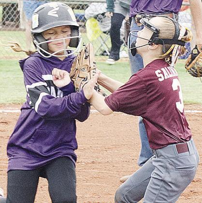 Clinton’s Vivien Salinas, right, tags the runner out during the Lady Reds’ first-round game against Elmore City Thursday during the OK Kids 8U State Softball Tournament at Schumacher Fields at Acme Brick Park. CDN | Sam Goodwyn