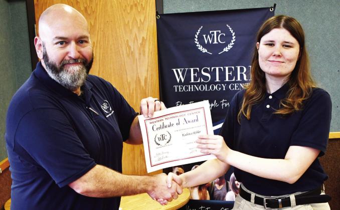Criminal justice student Kadence Kibler, right, from Clinton High School, receives the Outstanding Student of the Year Award from WTC instructor John Currid. CDN | Courtesy photo