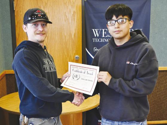 Welding student Aaron Lopez Martinez, right, from Clinton High School, receives the Outstanding Attitude of the Year Award from WTC instructor Kelly Vanderwork.