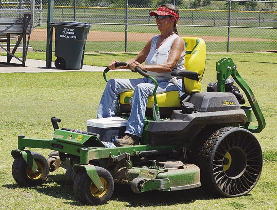 Sherrill Ausmus mows the grass at Schumacher Fields at Acme Brick Park Tuesday as the town prepares to host the OK Kids 8U Softball State Tournament starting today. CDN | Christian Jacobsen