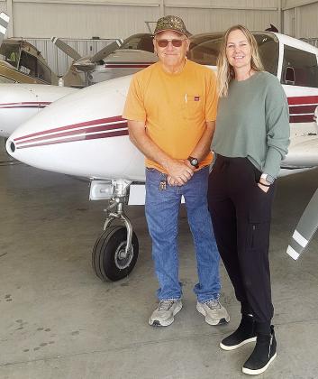 Larry Cornelson, left, and Tracy Yoder stand with her Twin Comanche Engine Airplane housed at Clinton Regional Airport. CDN | Shiann Dawson