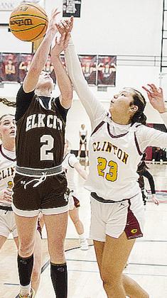 Lady Reds’ Ella Redshin, right, blocks an Elk City shot during Clinton’s playoff game Thursday against the Elkettes in Weatherford. CDN | Sam Goodwyn