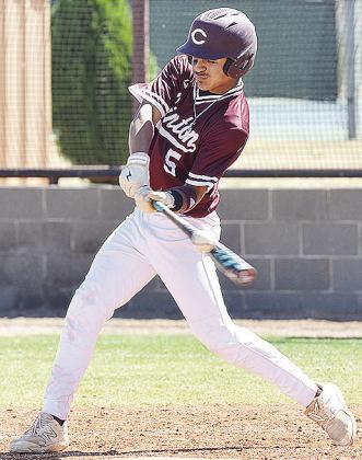 Clinton’s Jesus Gutierrez puts the bat on the ball as he records a hit during the Reds’ home loss Monday to the Bishop McGuiness Fighting Irish. CDN | Sam Goodwyn