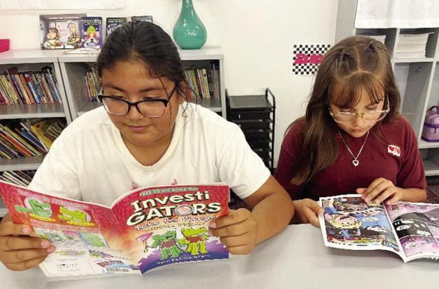 Checking out their free comic books are Southwest Elementary students Ximena Gamez and Yamilex Duran. CDN | Courtesy photo