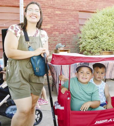 From left, Anna Carrillo takes Ceasar and Raphael Carillo to the Farmers Market at Engleman Park. CDN | Christian Jacobsen