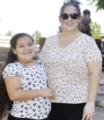 Layla Esparza, left, and Marquitta Moxley look at the products sold at the Farmers Market.