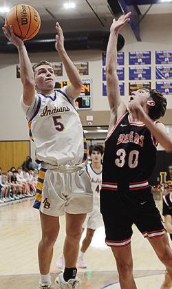 No. 5 Wesley Switzer lays the ball up over the defender during A-B’s home game against Cheyenne-Reydon. CDN | Sam Goodwyn