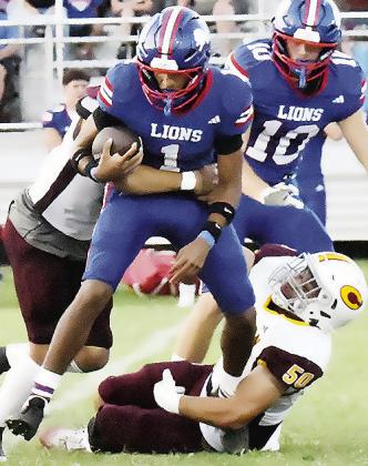 Clinton’s Easten Powell, left, and Alex Amaya work together to take down the Chandler ball carrier Friday during the Red Tornadoes’ road game. CDN | John Kinsey