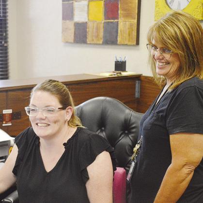 Nykki Mandrell, left, meets with Laura Haggard to set up a meeting at the front desk of the Clinton Public Schools Board of Education Administration Building.