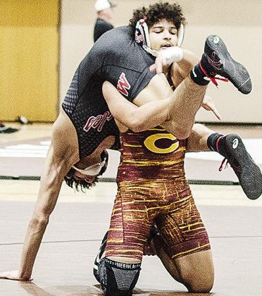 Clinton’s Jaden Potter fireman carries his opponent during his match in the Class 4A District Duals. CDN | Sam Goodwyn