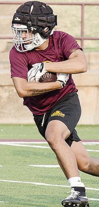 Cruz Rios holds onto the ball tight as he runs the ball during practice in the Tornado Bowl. CDN | Sam Goodwyn