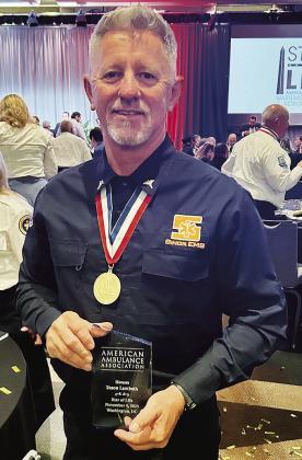 Sinor Emergency Medical Services EMT Jason Lambeth shows off his plaque and medal for being selected as the Oklahoma representative for the American Ambulance Association’s “Stars of Life” award in Washington, D.C. CDN | Courtesy photo