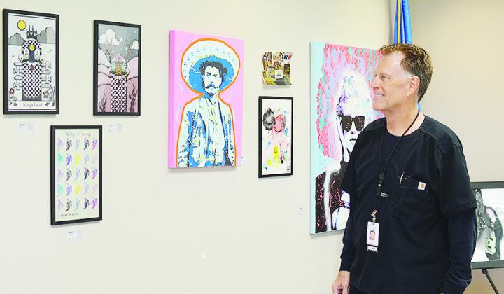 Pharmacist Cris Hickerson admires some of the new art installed at Clinton Regional Hospital. CDN | Micah Ashcraft
