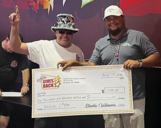 David Johnson, left, wins the St. Louis-style rib contest and is awarded $1,500 from General Manager Justin Twins at the Rib Cook Off Association Contest Saturday at Lucky Star Casino in Clinton. CDN | Courtesy photo