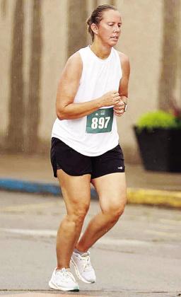 Newly-minted Clinton cross country coach Ashley Griffith runs down Frisco Avenue during the Clinton Classic Run this year. CDN | Courtesy photo