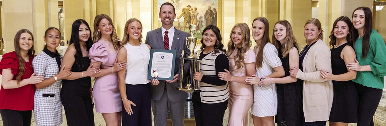 The Clinton dance team was recently honored at the State Capitol for its state title. Pictured, from left, are Coach Payten Childers, Alexandra Fuentes, Danna Mendieta, Stella Meacham, Jocelyn King, Speaker Pro Tempore Anthony Moore, Alexa Soto, Marli Hill, Quinn Moore, Whitney Salazar, Lyssa Day, Tatum Shackelford and Coach Emmerson McDonald. CDN | Courtesy photo