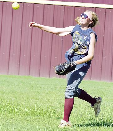 Clinton’s Madison Walker hurls the ball toward second base in a drill during practice. CDN | Sam Goodwyn