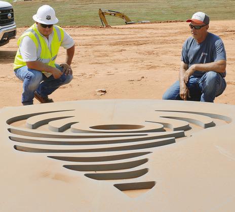 Project Manager Zach Whedbee, left, and Streets Maintenance Supervisor Craig Tucker look at the tornado form mold that will be used to decorate one of the future bridges being built on Interstate 40. CDN | Christian Jacobsen