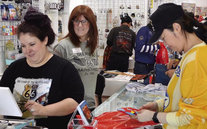 Khelsea Risinger, left, and Debbie Linderer, center, assist Joo Yeojin with her purchase Tuesday at the Oklahoma Route 66 Museum. Yeojin is on a trip with a larger group from South Korea. CDN | Christian Jacobsen