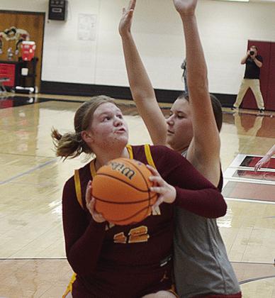 Clinton’s Lyssa Day, left, fights against a Weatherford defender as she tries to go up for a basket against the Eagles. CDN | Sam Goodwyn