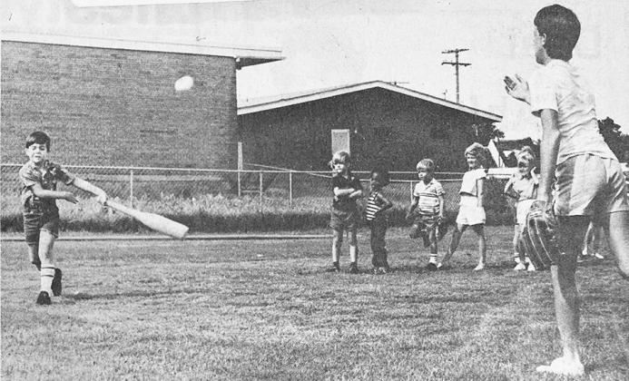 40 YEARS AGO Beau Hill puts bottle-shaped bat to ball during the Y-Tots-Kamp, conducted by the Clinton Area Family YMCA. Serving as pitcher was Jeff King, one of the camp assistants. The camp was for boys and girls age 4 through 6.